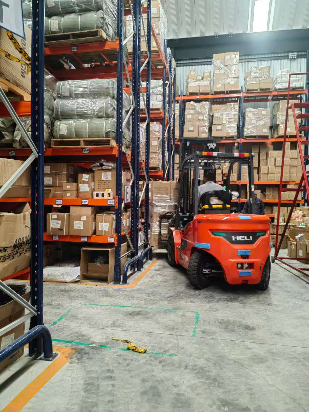 Forklift operating between warehouse racks in Mexico